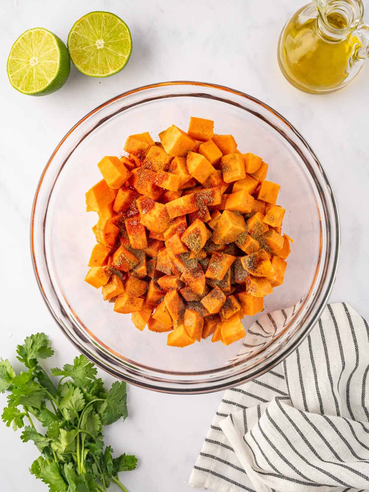 Seasoned sweet potatoes in a bowl.