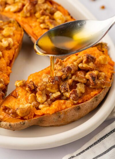 A drizzle of maple syrup is added to sweet potatoes.