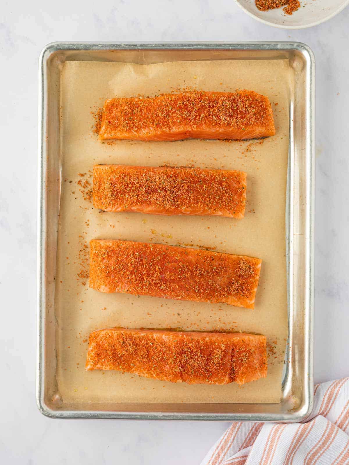 Salmon fillets rubbed with brown sugar seasoning.