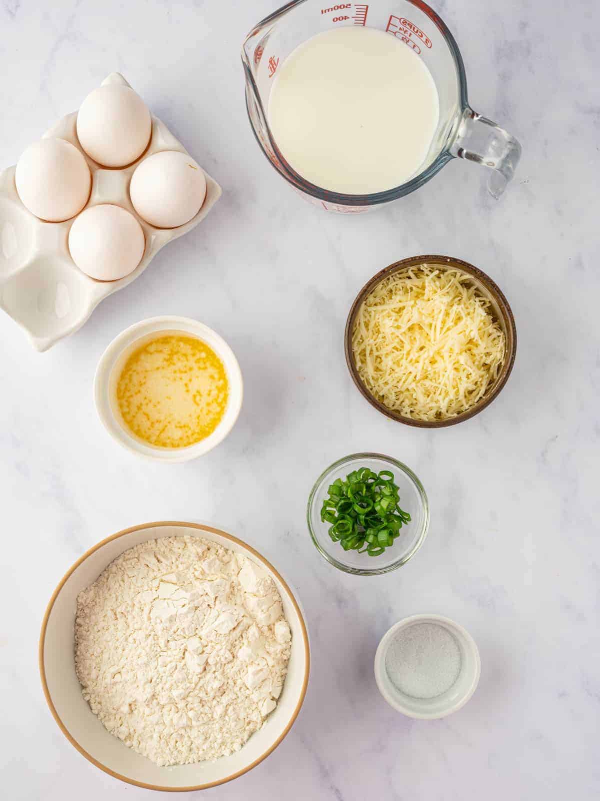 Eggs, milk, flour, cheddar, green onions, butter, and salt for cheese popovers.