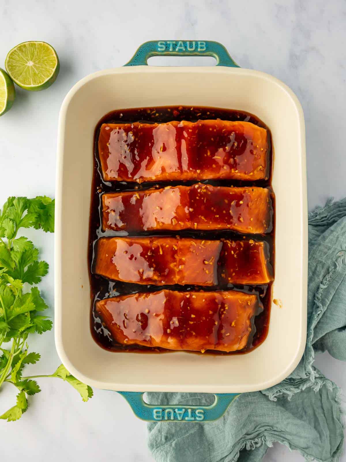 Marinated salmon in a baking dish,