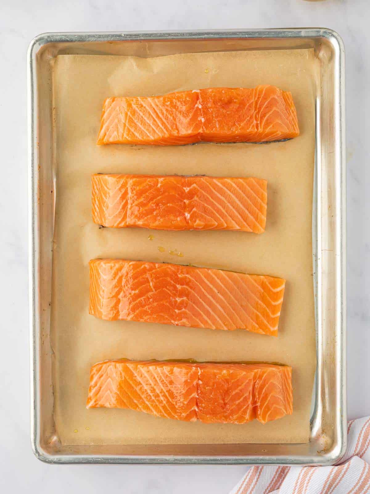 Fresh salmon filets on a tray.