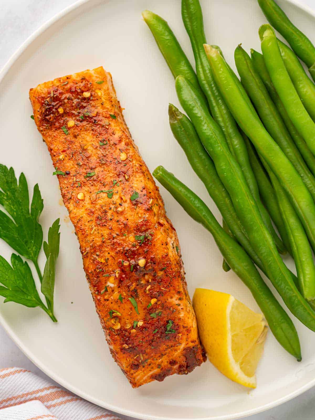 Salmon with brown sugar served with green beans.