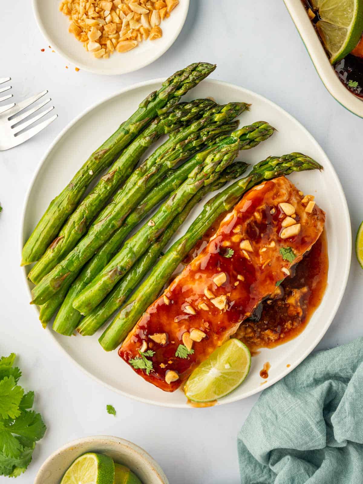 Salmon with thai marinade on a plate with asparagus.