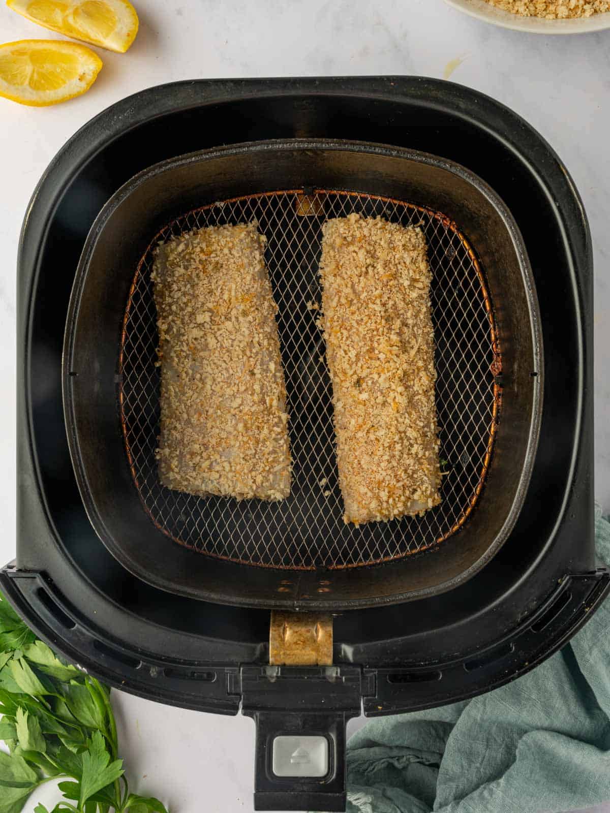 Breaded Mahi Mahi fish in the air fryer before cooking.