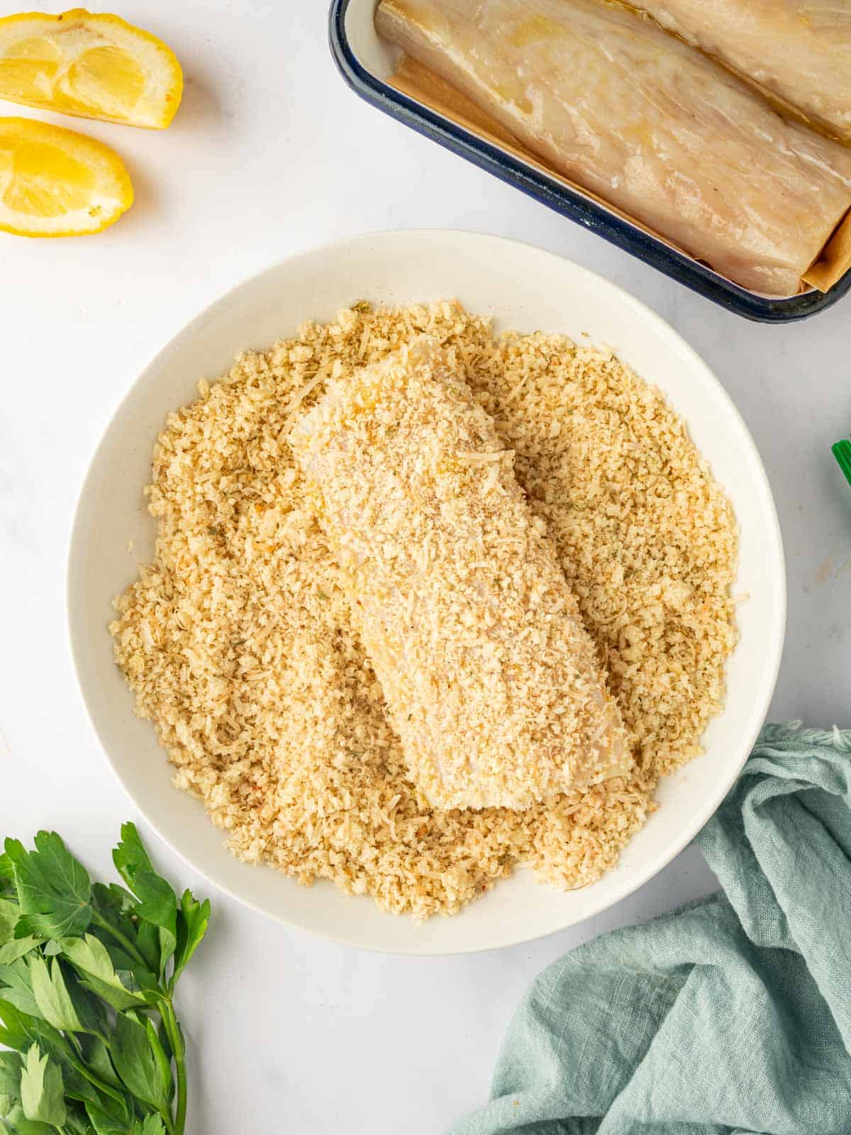 Coating mahi mahi fish with panko crumbs.