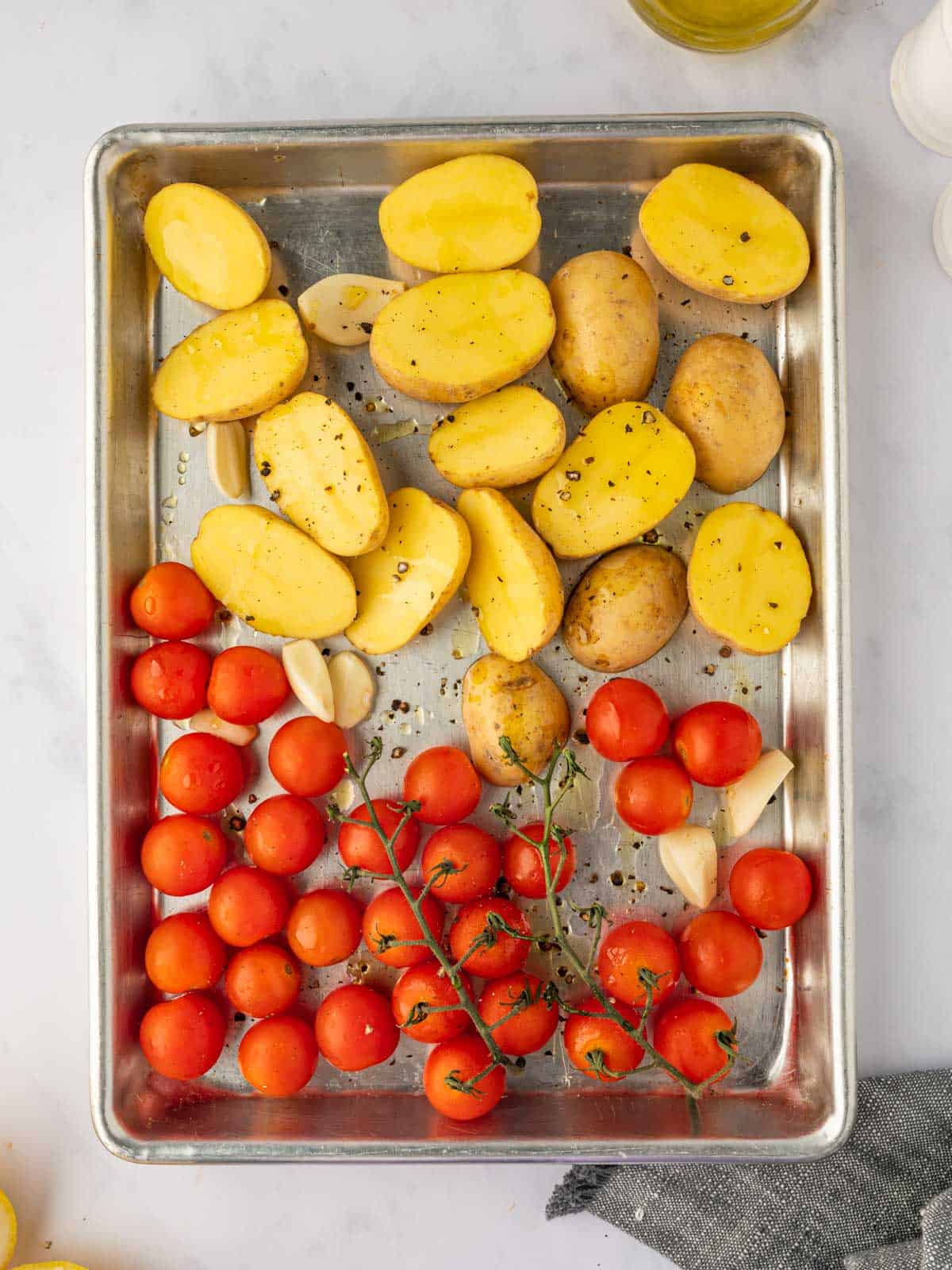 Potatoes and tomatoes on a tray.