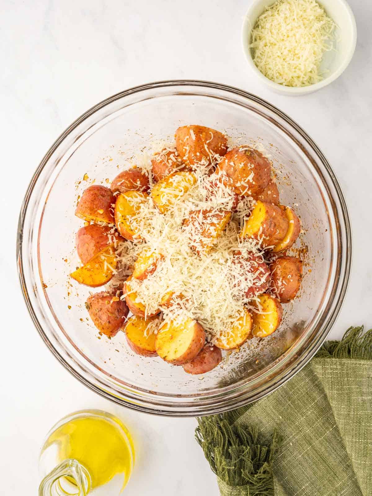 Parmesan cheese is sprinkled over potatoes.