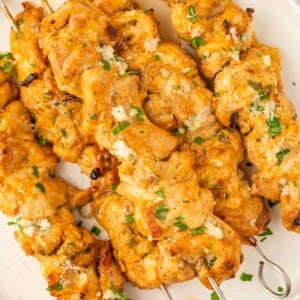 Oven chicken skewers on plate.