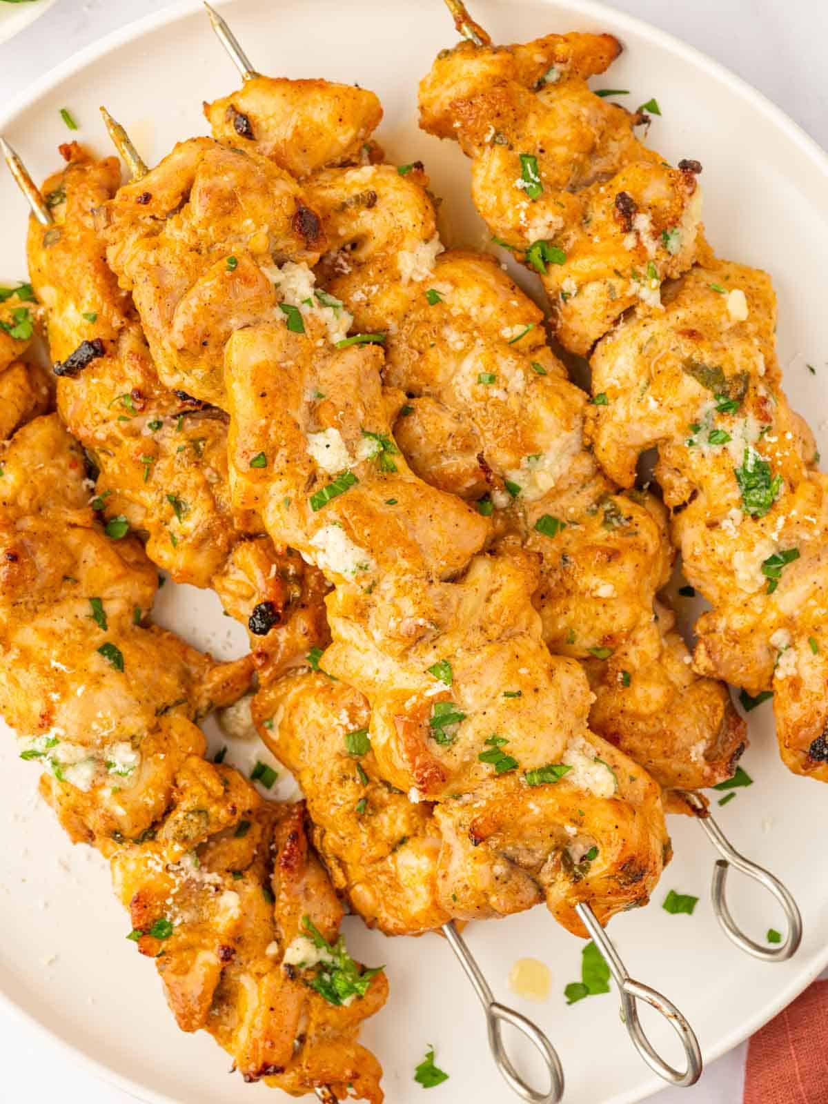 Oven chicken skewers on plate.