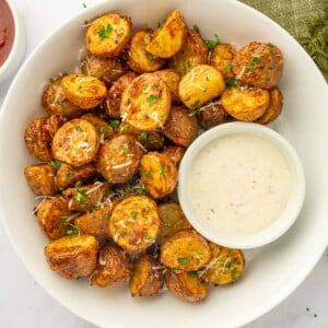 A platter of crispy air fried potatoes and dip.