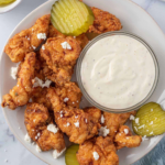 Crispy Nashville chicken tenders served with pickles, crumbled feta, and creamy ranch.