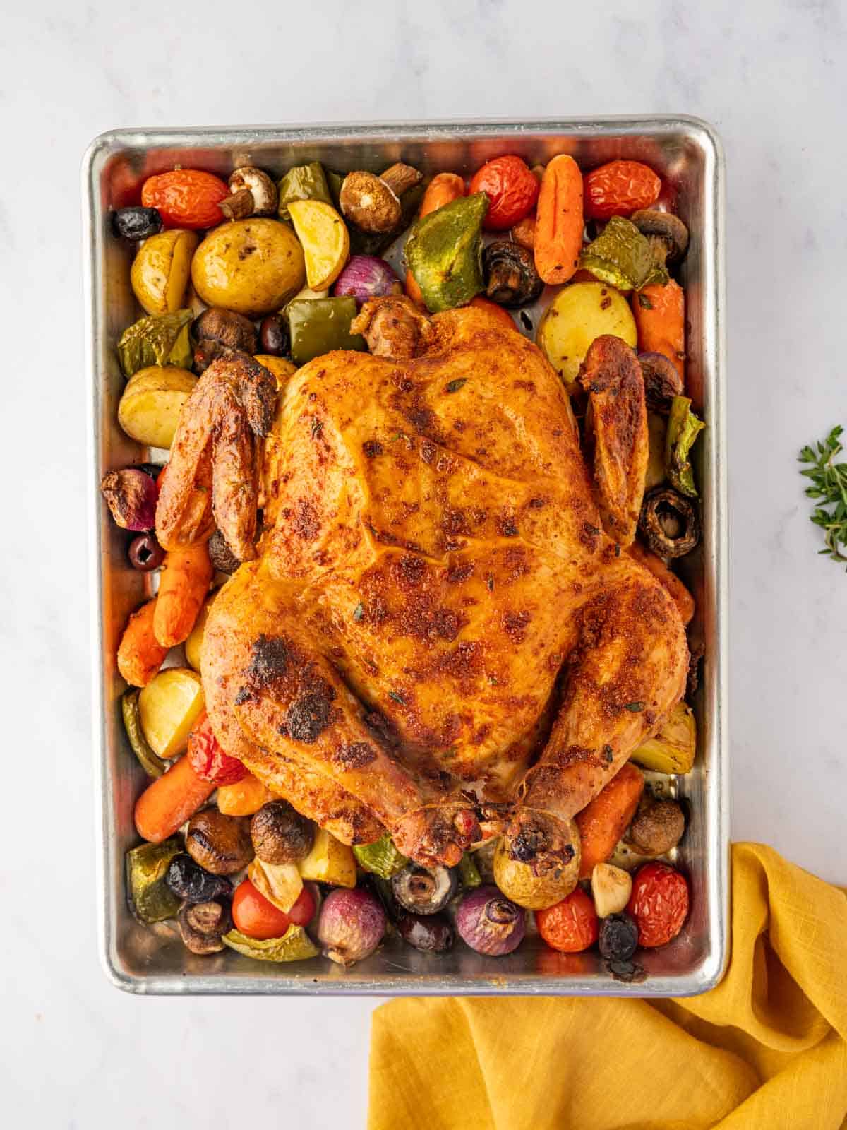 Roasted chicken sheetpan dinner with mediterranean seasoning.