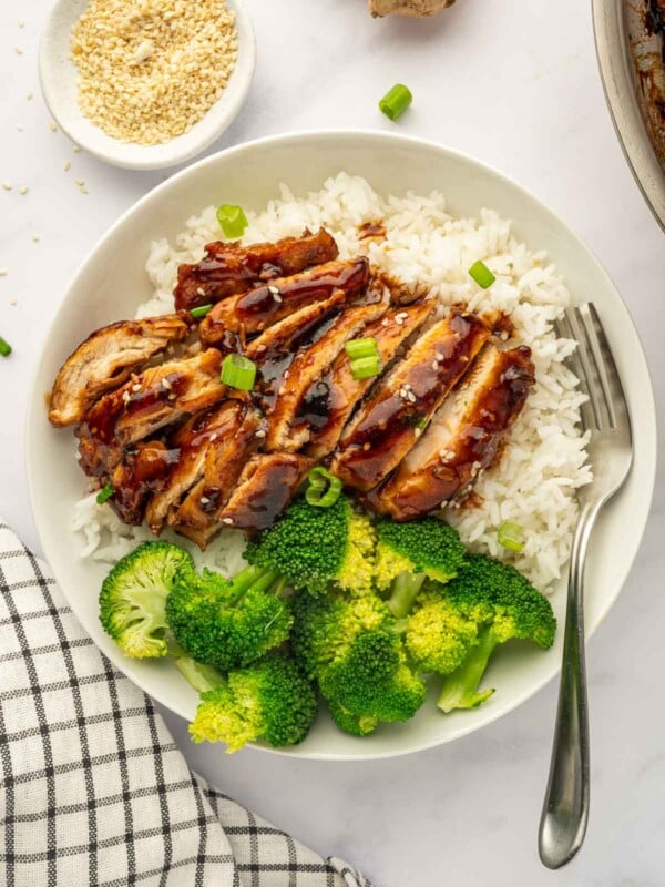 A single serving of Panda express teriyaki chicken on a plate with rice and broccoli.