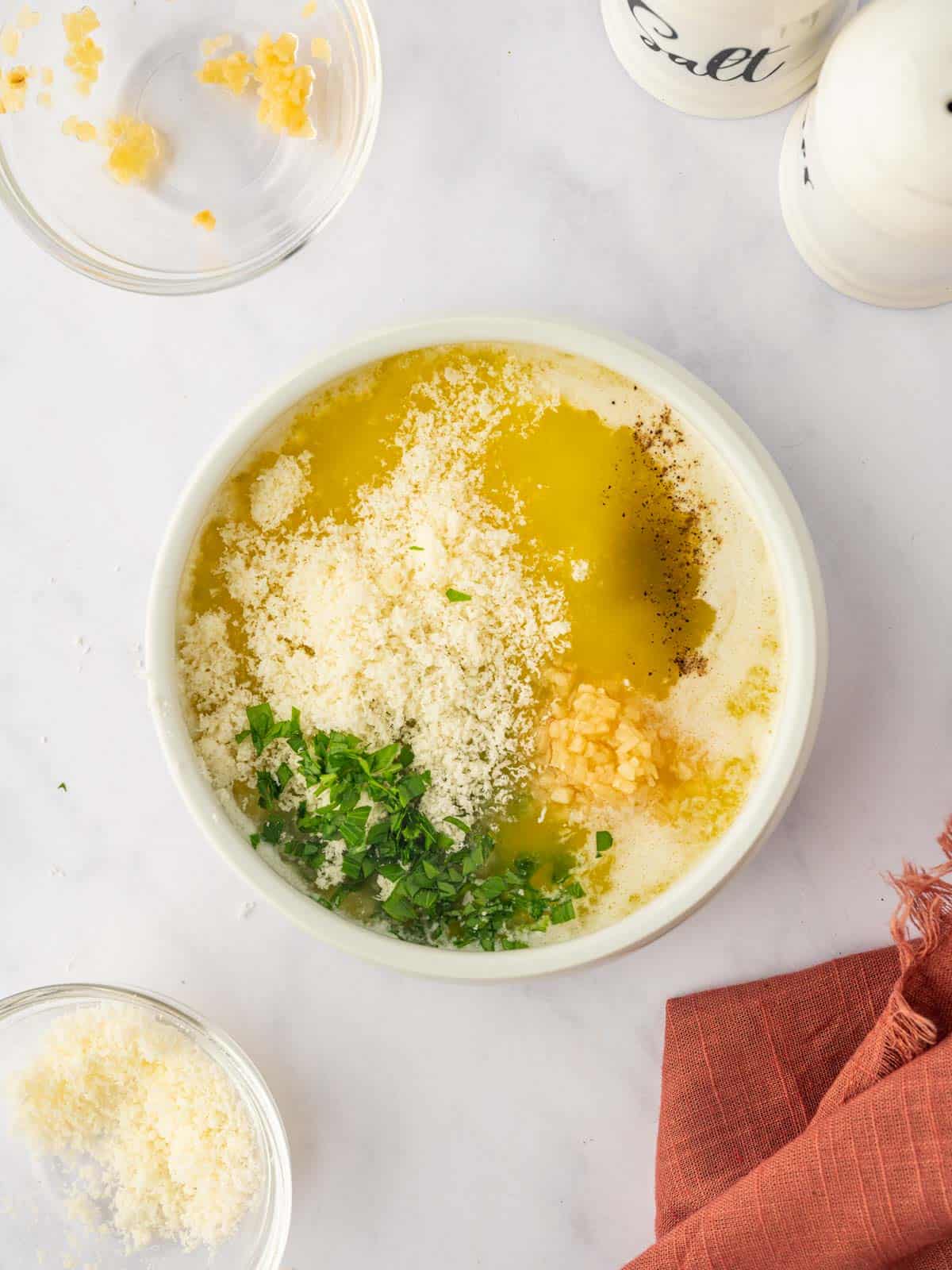 Parmesan butter sauce being mixed in a bowl.