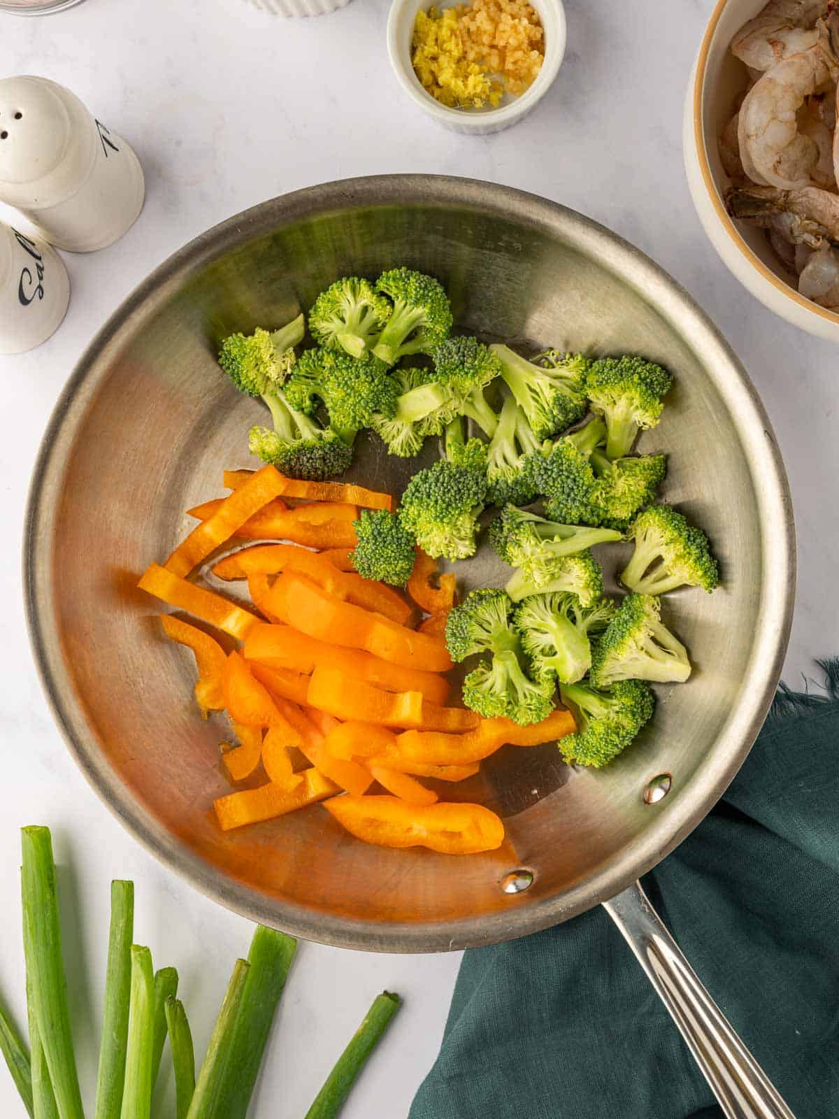 Stir fry vegetables in a skillet.