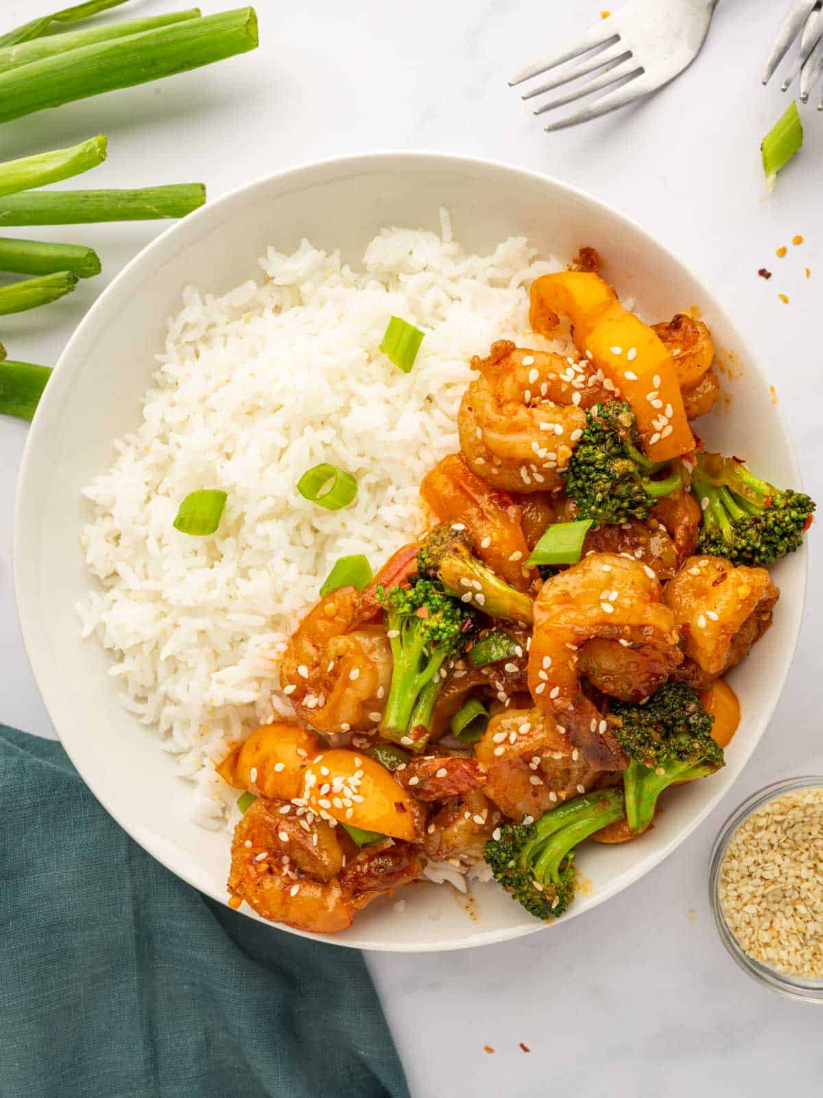 Sweet chili shrimp on a plate with rice.