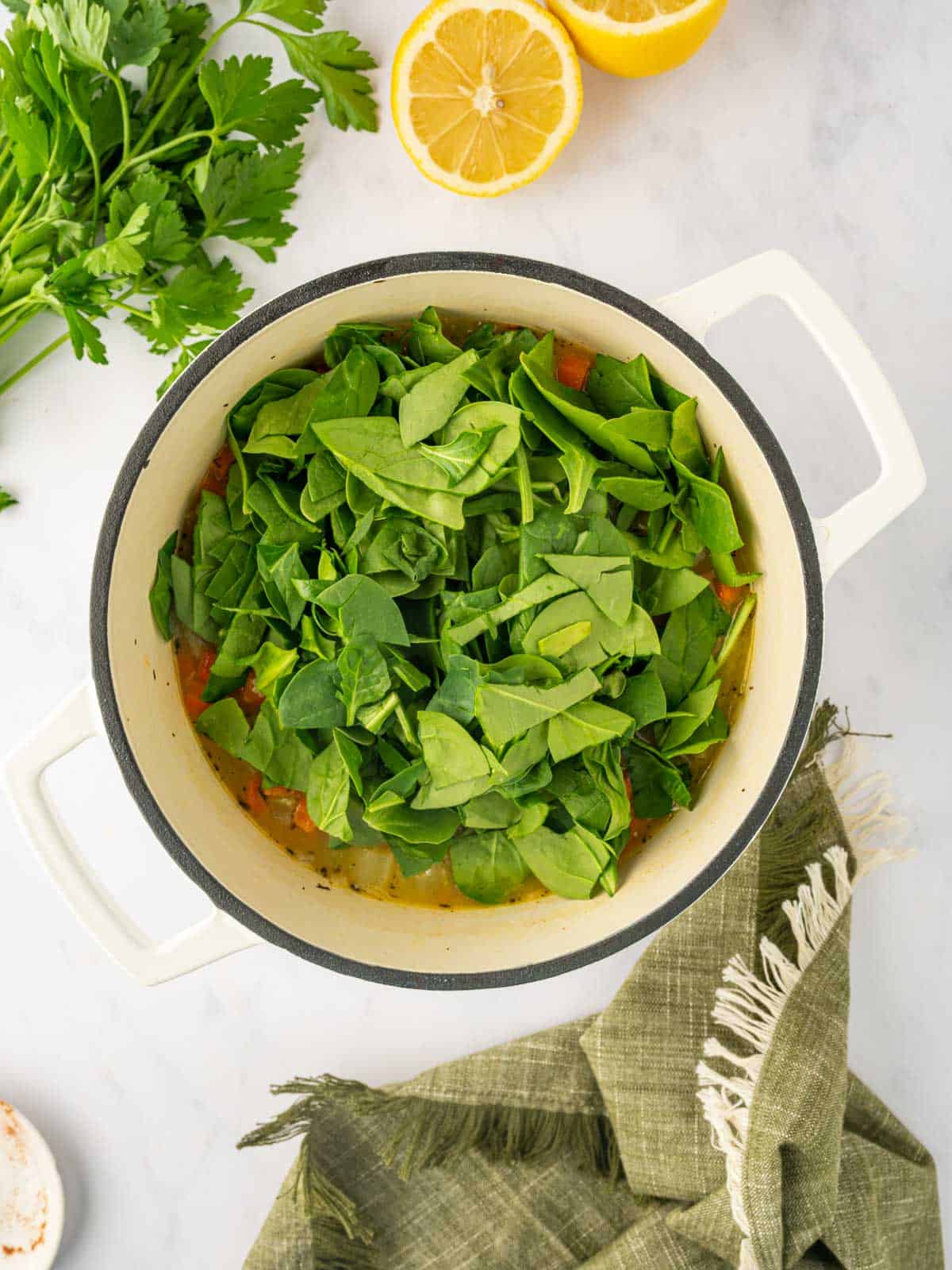 Chopped spinach is added to the broth.