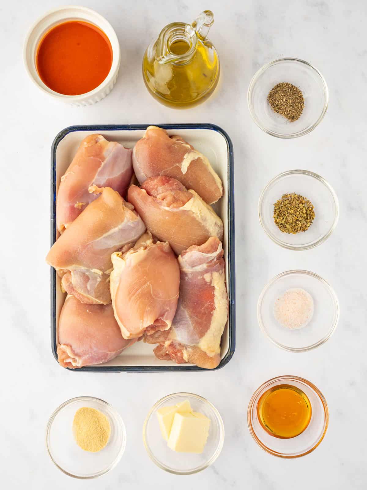 Ingredients needed for baked buffalo chicken thighs.