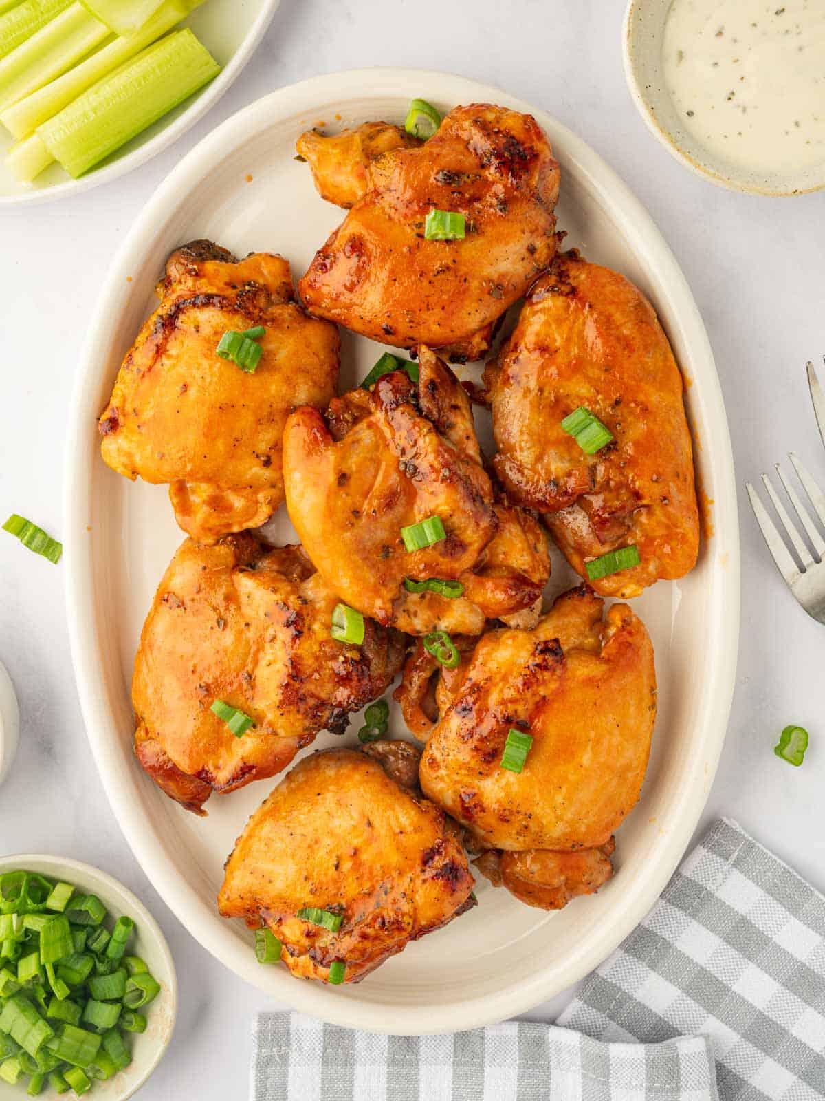 Baked buffalo chicken on a platter.