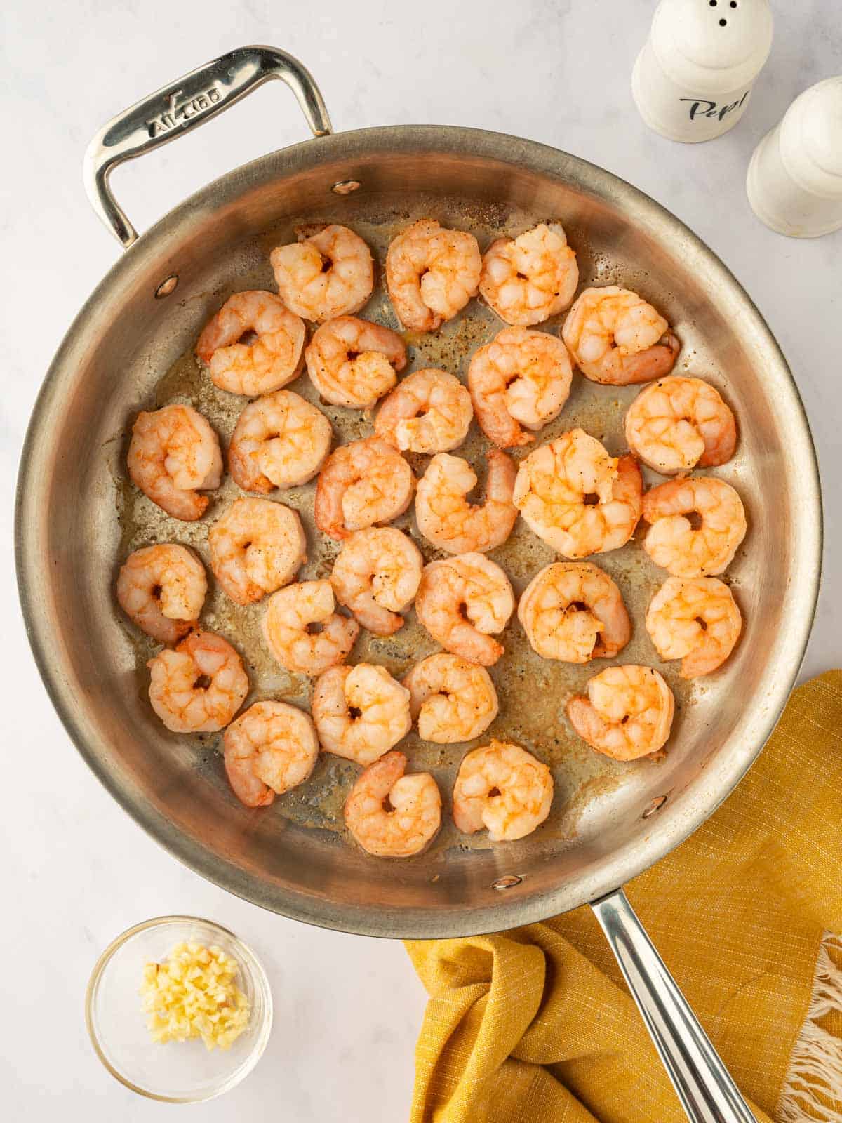 Cooked shrimp in a skillet.