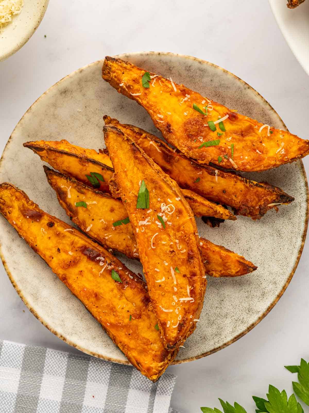 Several sweet potato wedges on a plate.