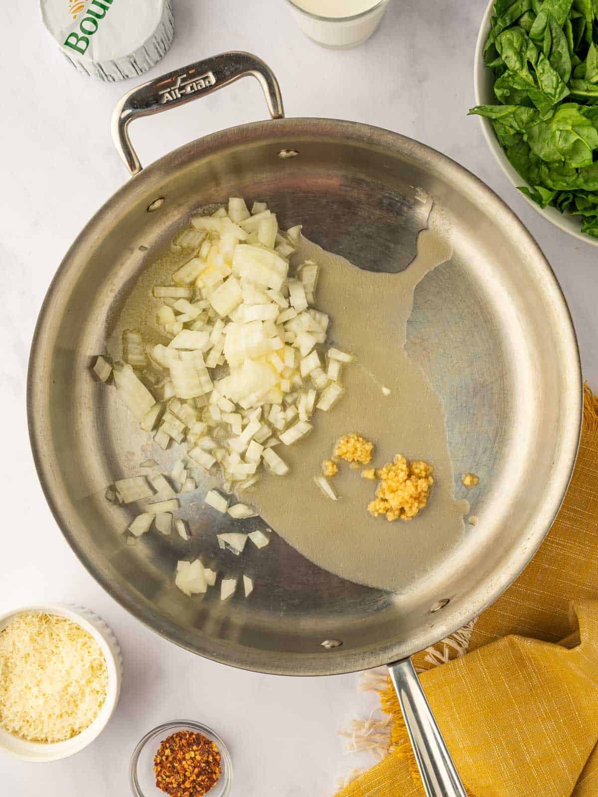 Saute onions and garlic in a skillet.