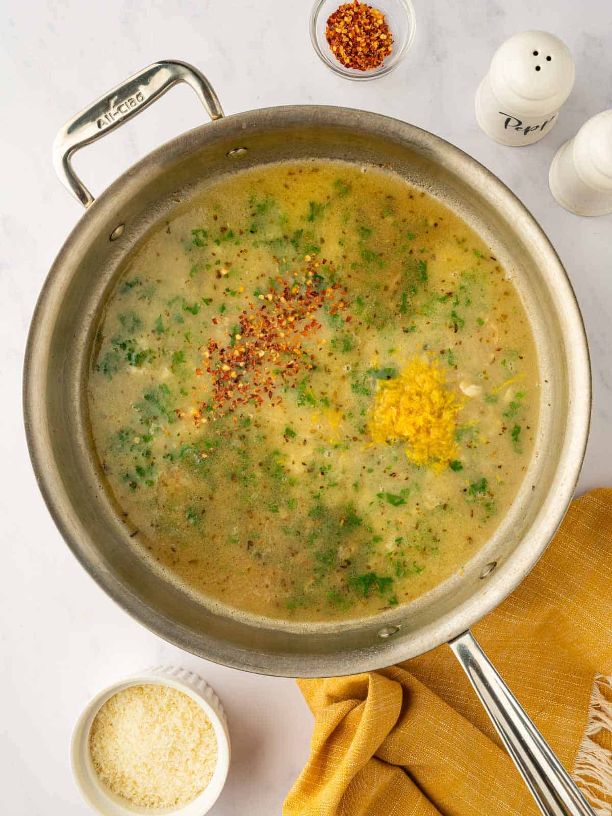 Adding herbs and seasonings to the skillet.