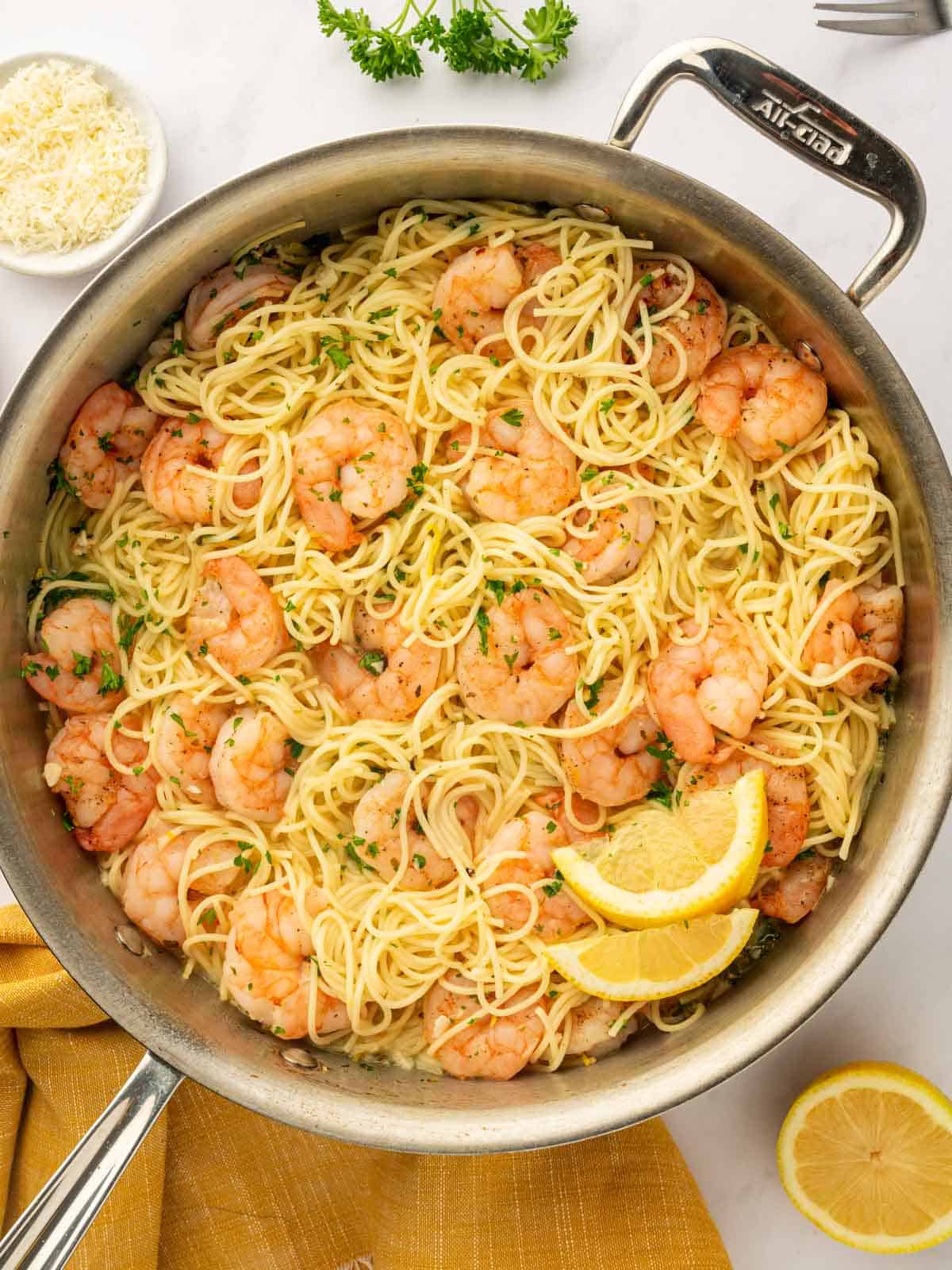A skillet of pasta and shrimp.
