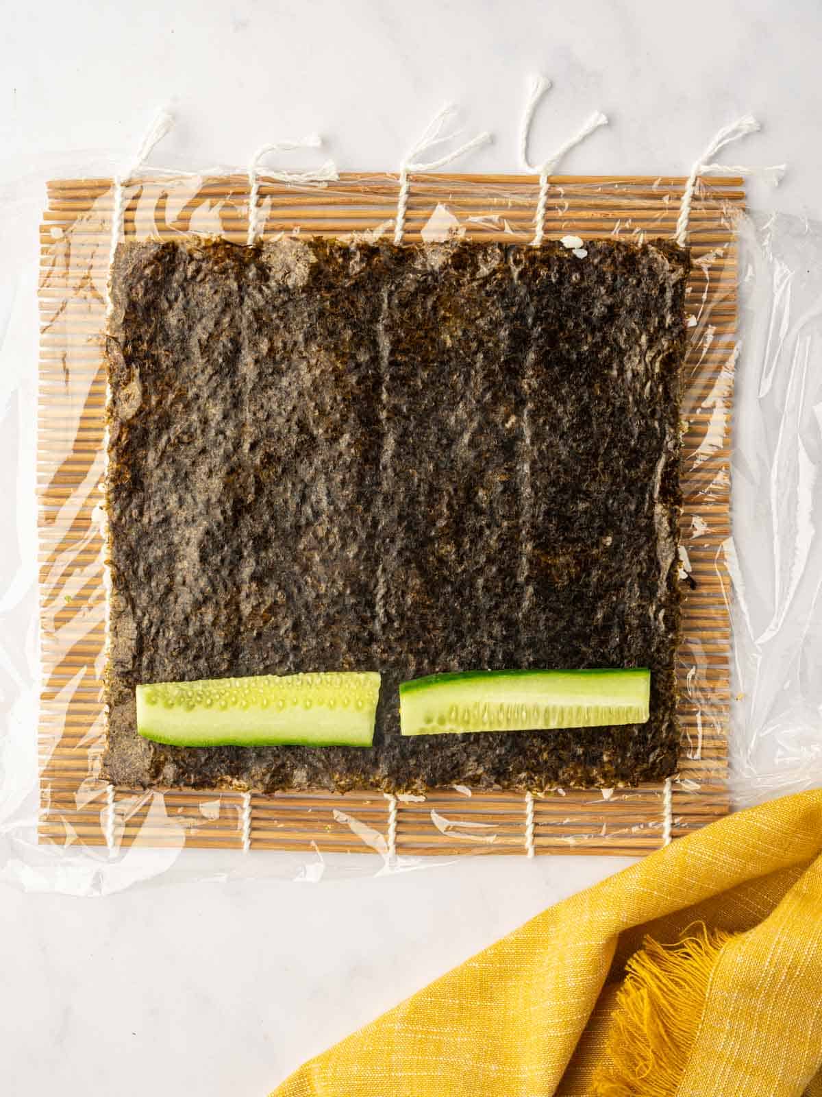 Cucumber is layered on the nori.