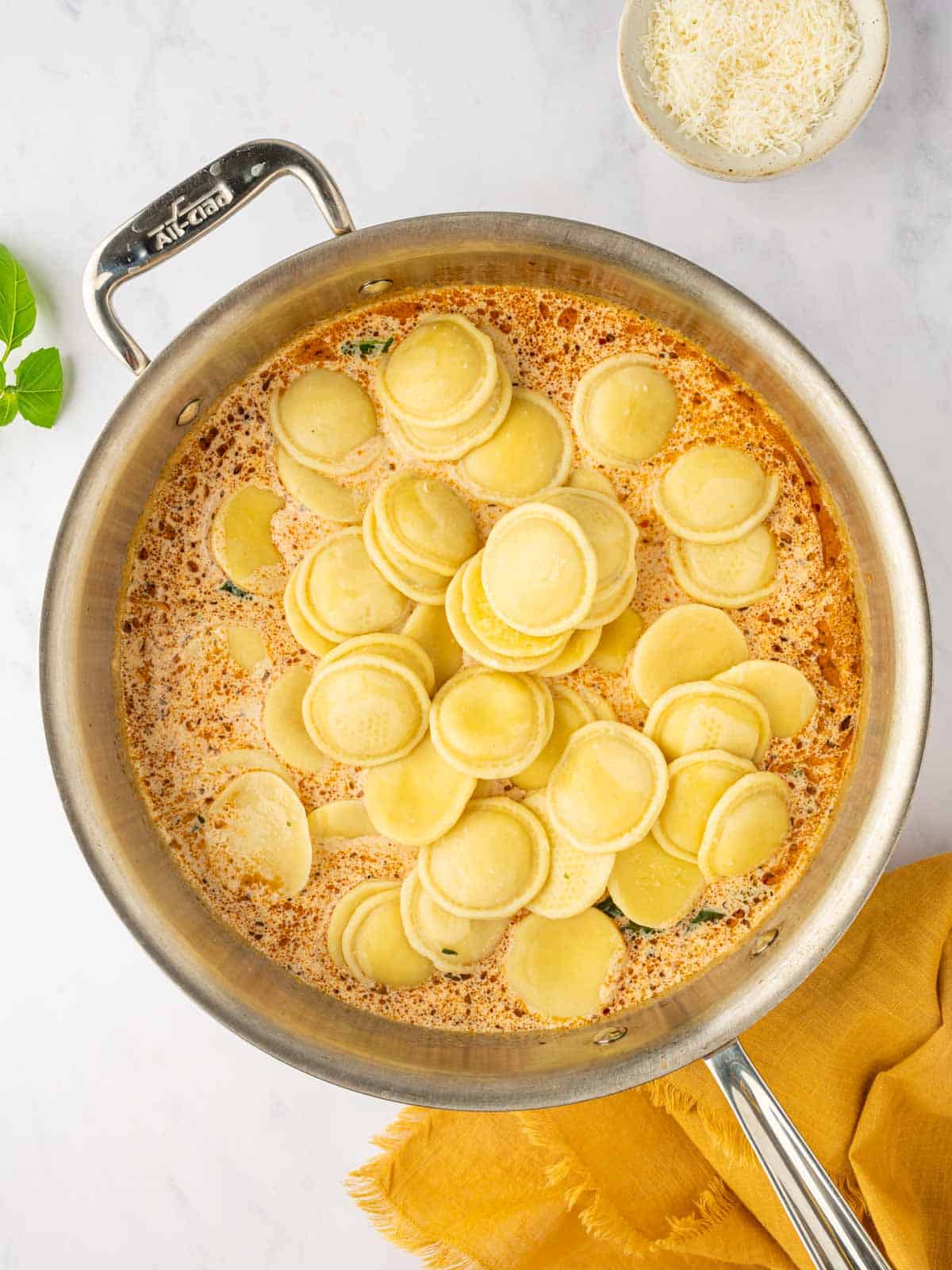 Cooked ravioli is added to the sauce.