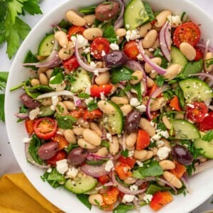 A large bowl of salad with beans and veggies.