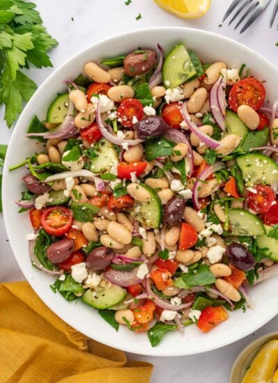A large bowl of salad with beans and veggies.