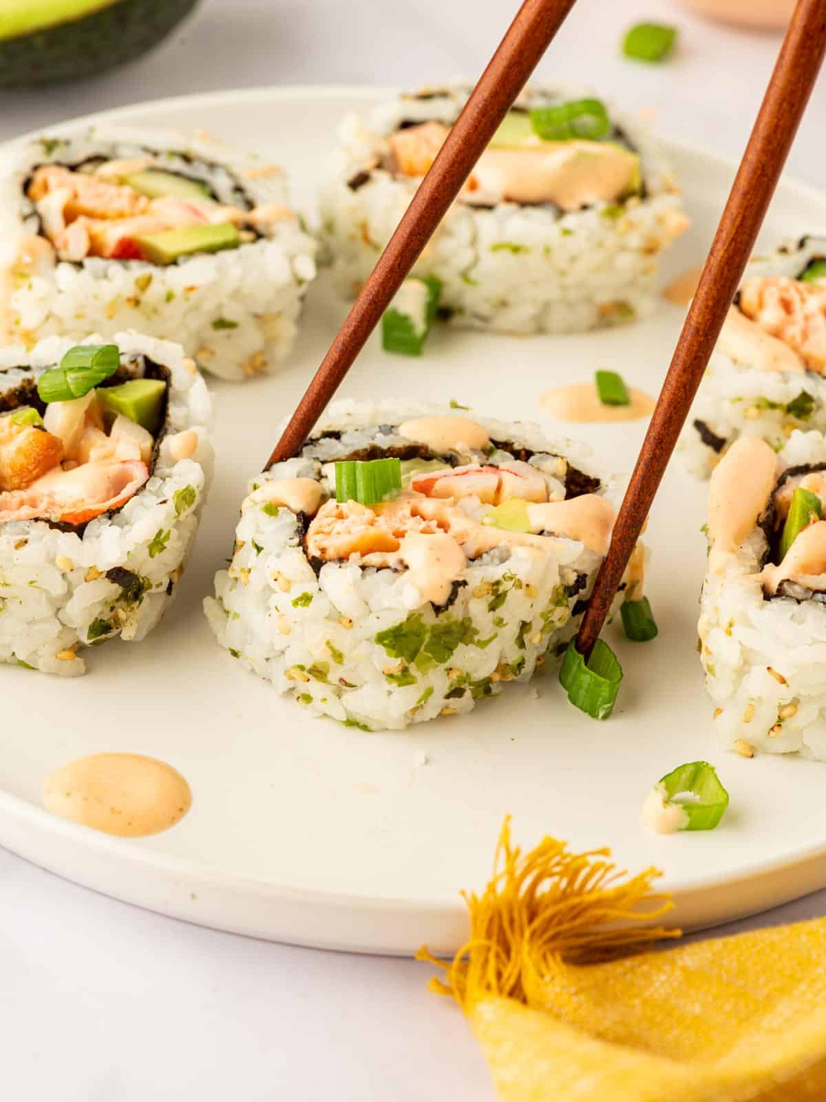 Chopsticks pick of a piece of sushi.