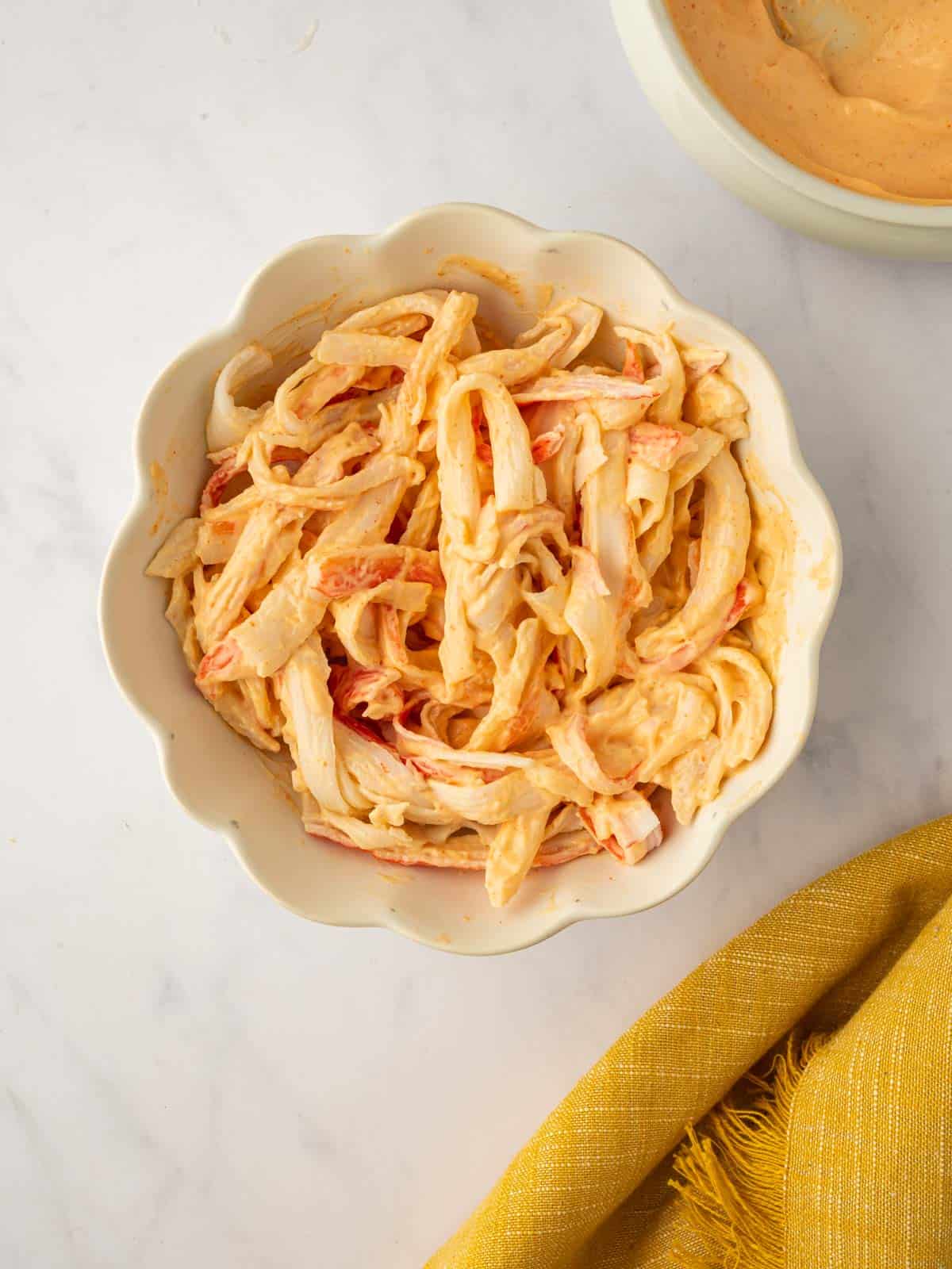 Shreeded crab is tossed with spicy mayo.