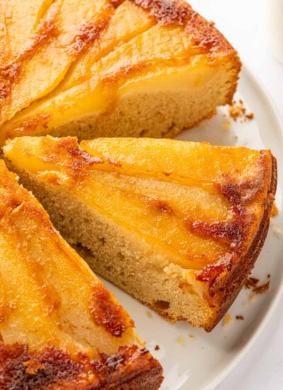 Slices of upside down pear cake on a plate.