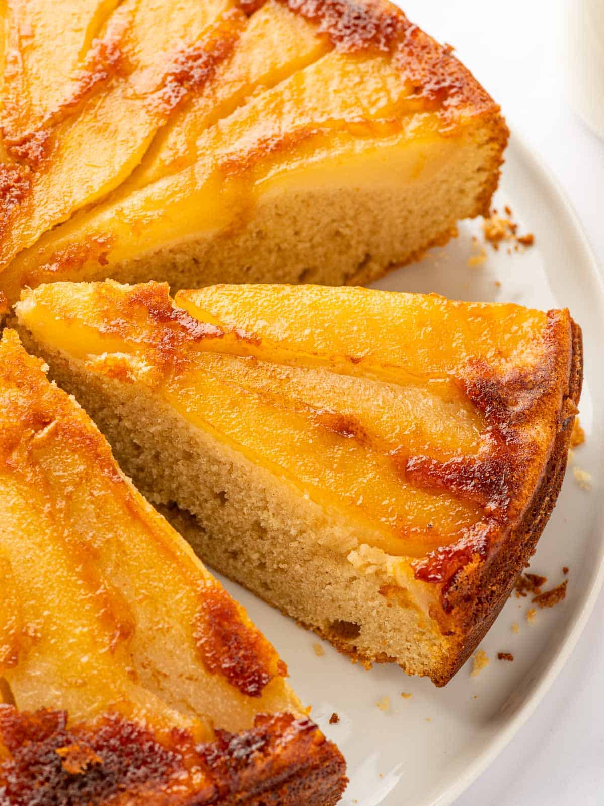 Slices of upside down pear cake on a plate.