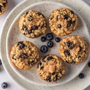 Oatmeal cups with blueberries on a plate.