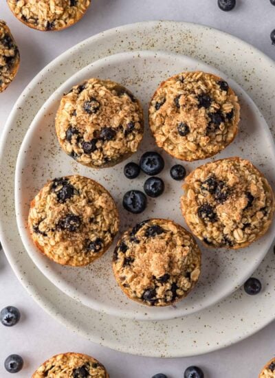Oatmeal cups with blueberries on a plate.