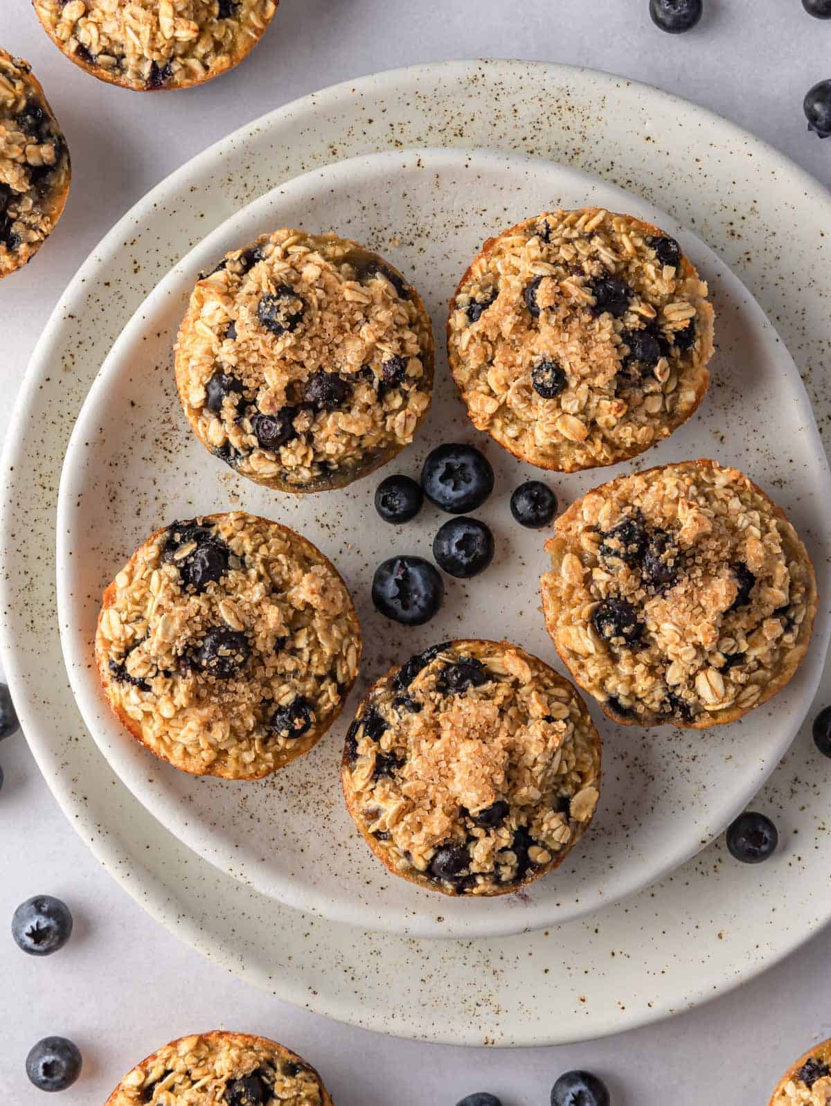 Oatmeal cups with blueberries on a plate.