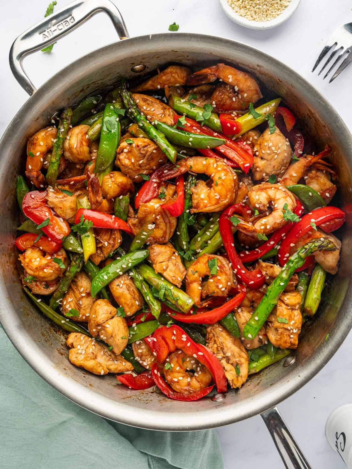Chicken and shrimp stir fry in a pan.