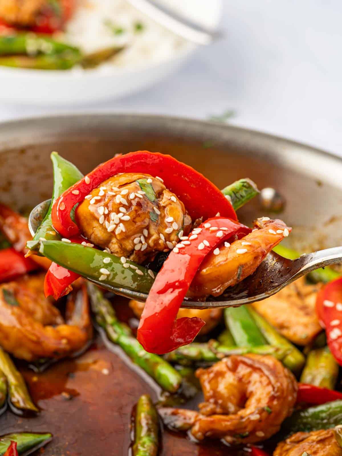 Close up of chicken and shrimp on a spoon.