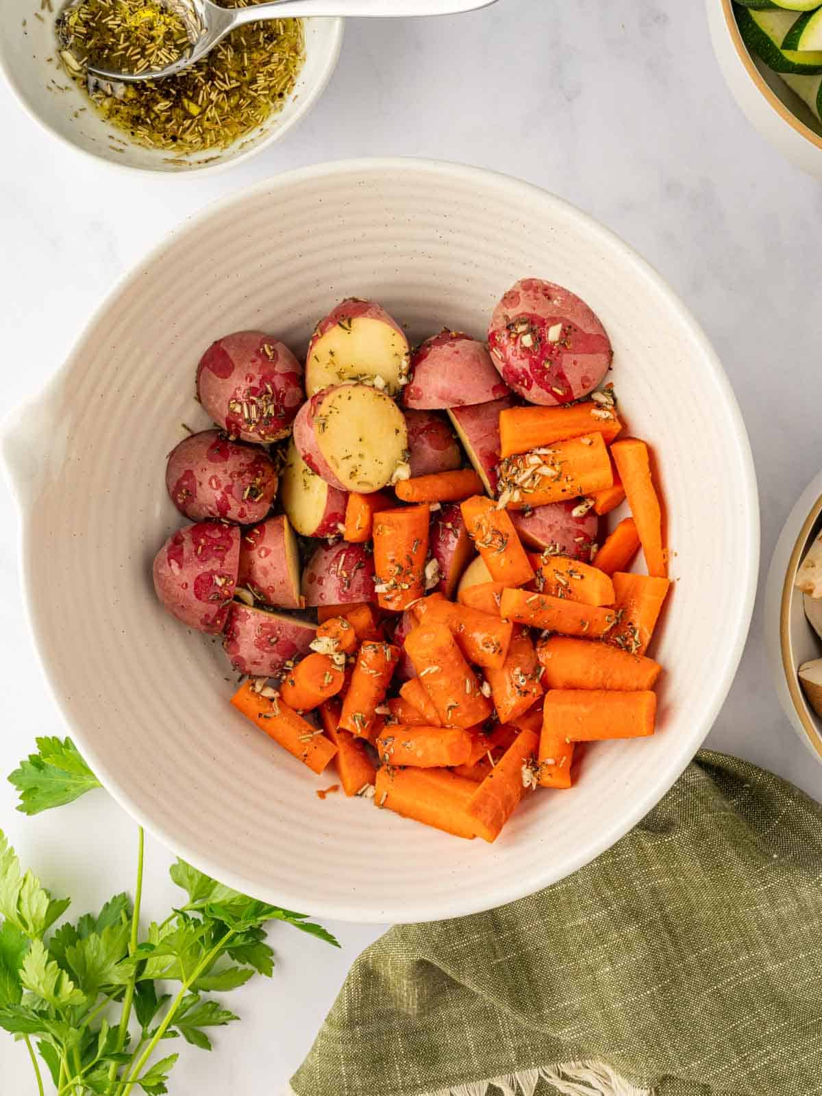 Marinated carrots and potatoes in a bowl.