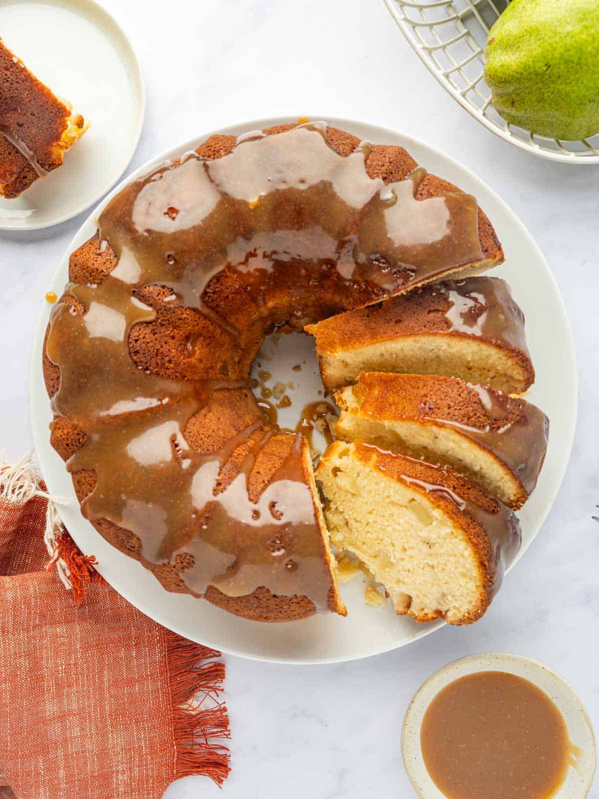 Sliced pear cake with caramel.