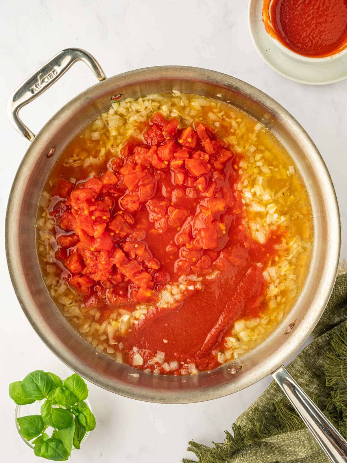 Add the tomatoes to the skillet for the pasta sauce.