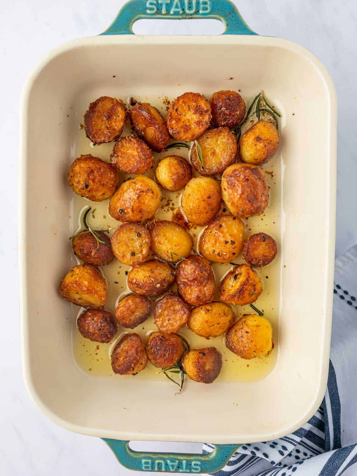 A casserole dish with crispy golden potatoes.