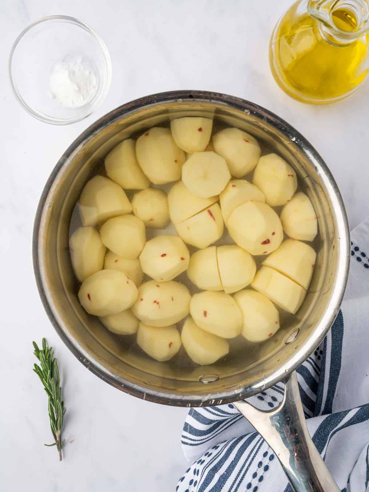 Potatoes are boiled in salted water with baking soda.