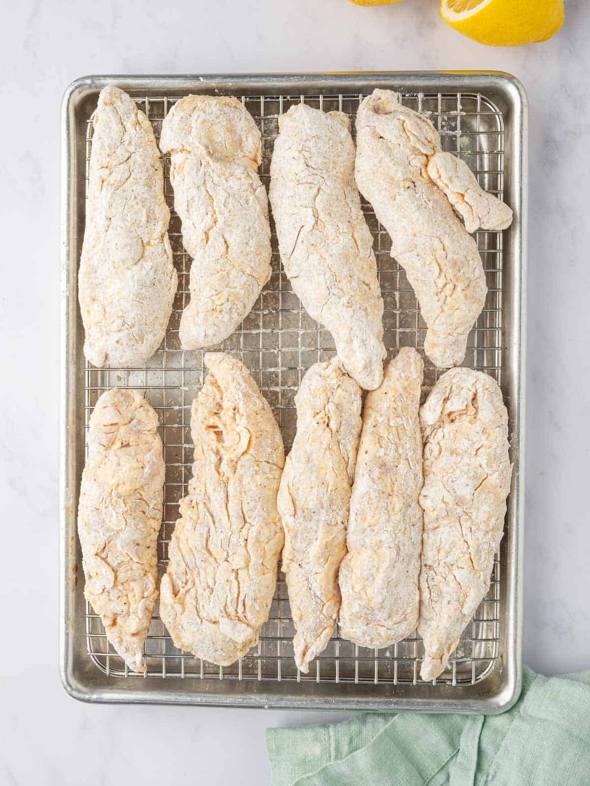 Rest the breaded chicken fingers on a baking rack.