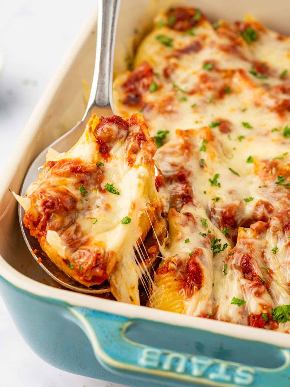 Beef stuffed shells in a spoon.