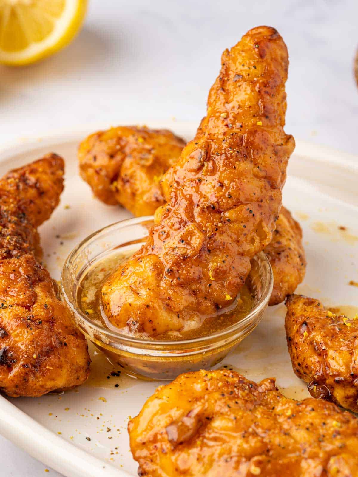 Dip lemon pepper chicken in a honey sauce.